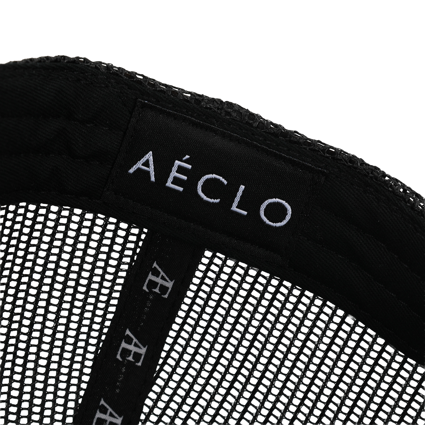 Close-up of a black mesh product with 'Aéclo' branding on a white background