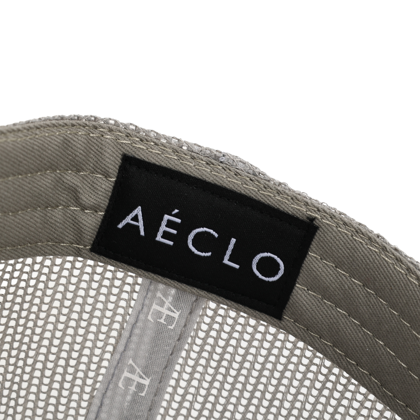 biege Interior view of beige AÉCLO cap showcasing embroidered logo and size tag