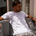Model wearing  white t-shirt with clean trim and subtle AÉCLO logo