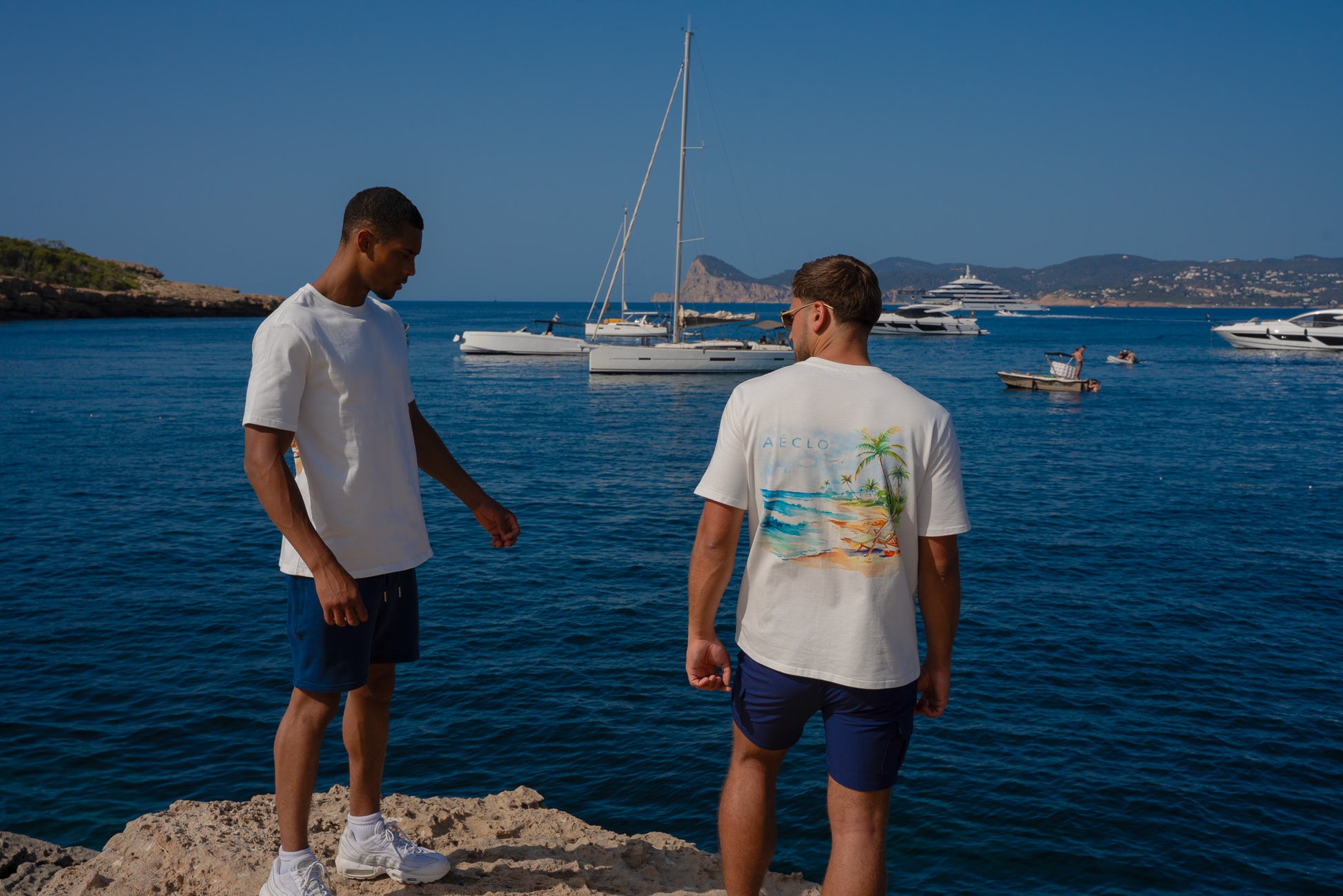 Model wearing navy blue slim-fit cargo shorts by AÉCLO against a bright backdrop