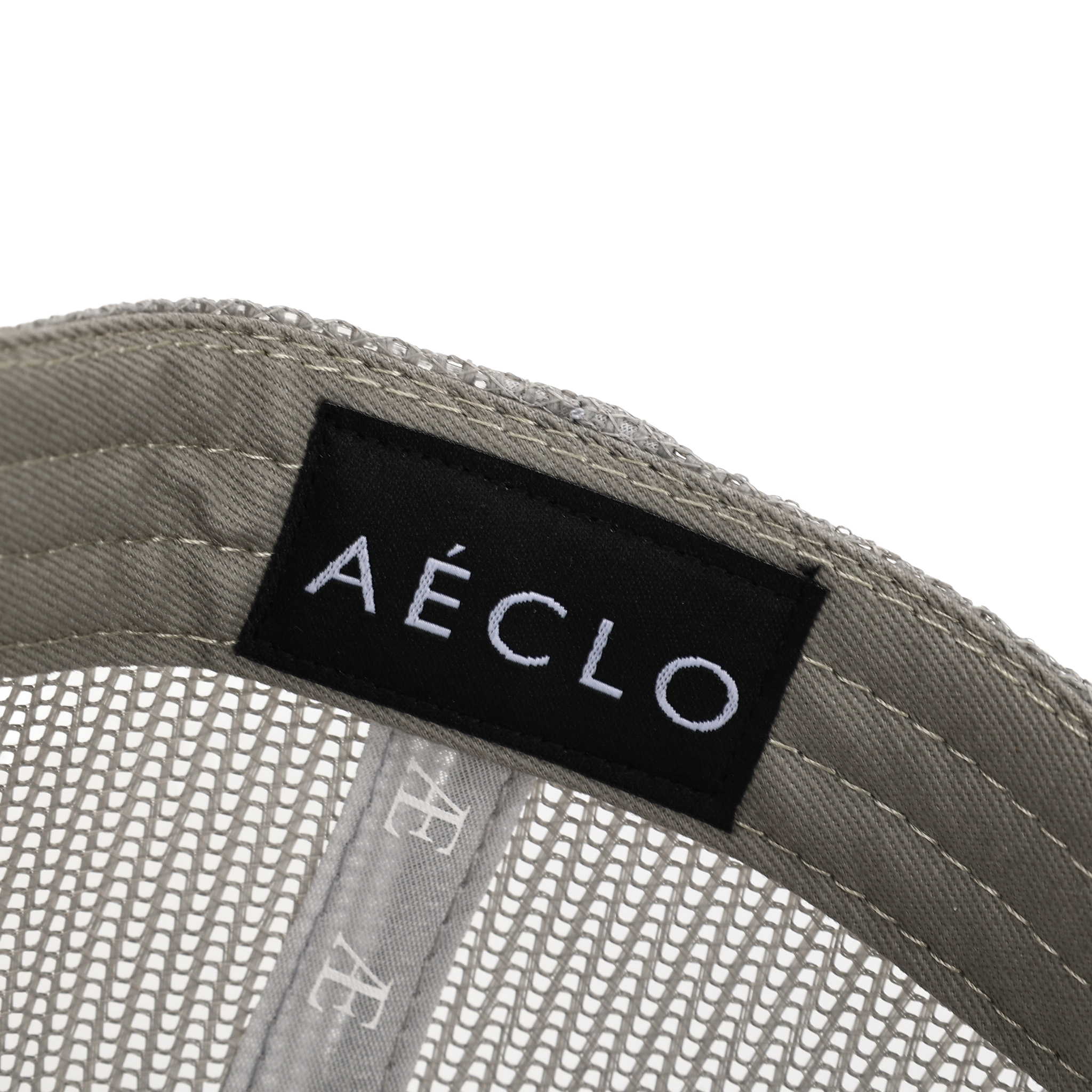 biege Interior view of beige AÉCLO cap showcasing embroidered logo and size tag